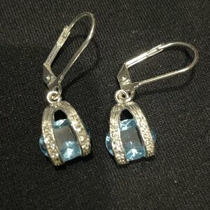 Silver dangle earrings with light blue stone